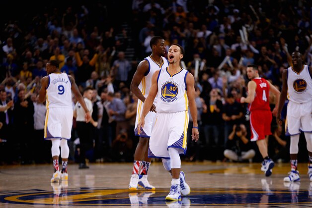 OAKLAND, CA - NOVEMBER 04:  Stephen Curry #30 of the Golden State Warriors reacts after he made a basket over DeAndre Jordan #6 in the fourth quarter at ORACLE Arena on November 4, 2015 in Oakland, California. NOTE TO USER: User expressly acknowledges and agrees that, by downloading and or using this photograph, User is consenting to the terms and conditions of the Getty Images License Agreement.  (Photo by Ezra Shaw/Getty Images)