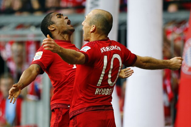 Bayern's Douglas Costa, left, and teammate Arjen Robben celebrate after Robben scored his side's opening goal during the German Bundesliga soccer match between FC Bayern Munich and VfB Stuttgart in Munich, Germany, Saturday, Nov. 7, 2015. (AP Photo/Matthias Schrader)
