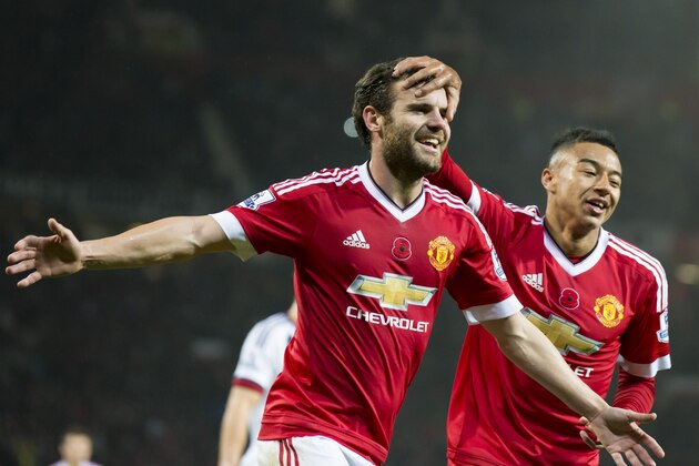 Manchester United's Juan Mata, centre, celebrates with teammate Jesse Lingard after scoring against West Bromwich Albion's during the English Premier League soccer match between Manchester United and West Bromwich Albion at Old Trafford Stadium, Manchester, England, Saturday, Nov. 7, 2015. (AP Photo/Jon Super)