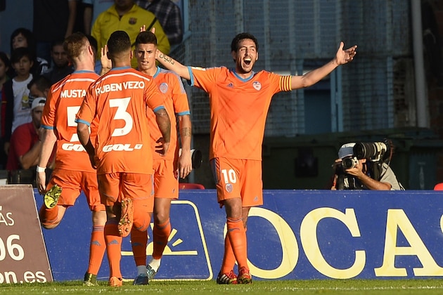 Valencia's midfielder Dani Parejo (R) celebrates after scoring a goal during the Spanish league football match RC Celta de Vigo vs Valencia CF at the Balaidos stadium in Vigo on November 7, 2015. Valencia won the match 5-1.   AFP PHOTO/ MIGUEL RIOPA        (Photo credit should read MIGUEL RIOPA/AFP/Getty Images)
