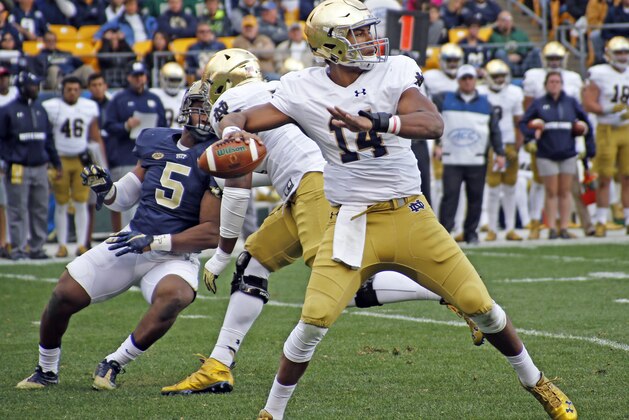 Notre Dame quarterback DeShone Kizer (14) looks to pass as Pittsburgh defensive lineman Ejuan Price (5) rushes in the second quarter of an NCAA football game, Saturday, Nov. 7, 2015 in Pittsburgh. (AP Photo/Keith Srakocic)