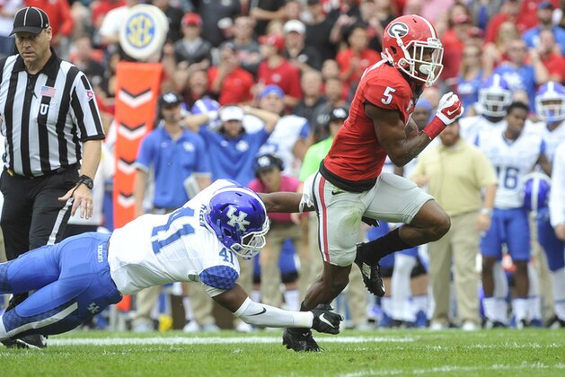 Georgia wide receiver Terry Godwin (5) breaks away from the tackle of Kentucky cornerback J.D. Harmon (11) during the first half of an NCAA college football game, Saturday, Nov. 7, 2015, in Athens, Ga. (AP Photo/John Amis)