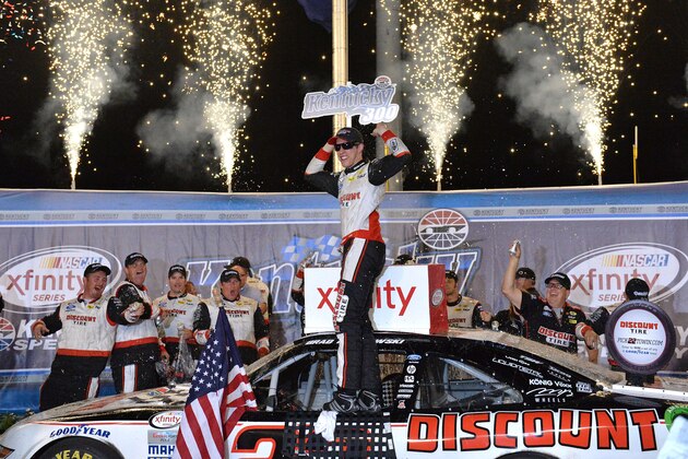 Brad Keselowski celebrates in Victory Lane following his win in the NASCAR Xfinity Series auto race at Kentucky Speedway in Sparta, Ky., Friday, July 10, 2015. (AP Photo/Timothy D. Easley)