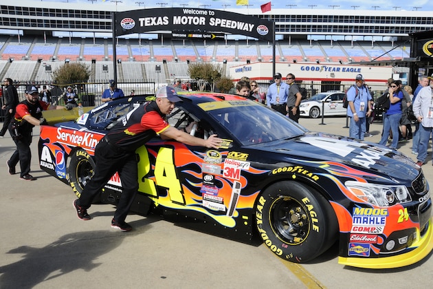 Jeff Gordon's crew pushes his car in the garage area before NASCAR Sprint Cup auto racing practice at Texas Motor Speedway Friday, Nov. 6, 2015, in Fort Worth, Texas. (AP Photo/Larry Papke)