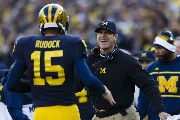 Nov 7, 2015; Ann Arbor, MI, USA; Michigan Wolverines quarterback Jake Rudock (15) receives congratulations from head coach Jim Harbaugh after passing for a touchdown in the first quarter against the Rutgers Scarlet Knights at Michigan Stadium. Mandatory Credit: Rick Osentoski-USA TODAY Sports