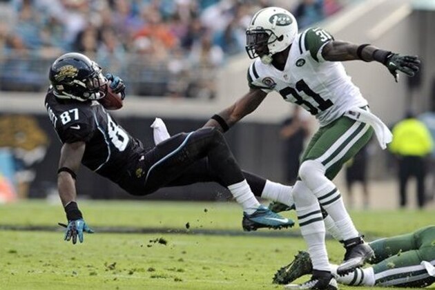 Jacksonville Jaguars wide receiver Kevin Elliott (87) falls backward in front of New York Jets cornerback Antonio Cromartie (31) after a reception during the first half of an NFL football game, Sunday, Dec. 9, 2012, in Jacksonville, Fla. (AP Photo/Stephen Morton)