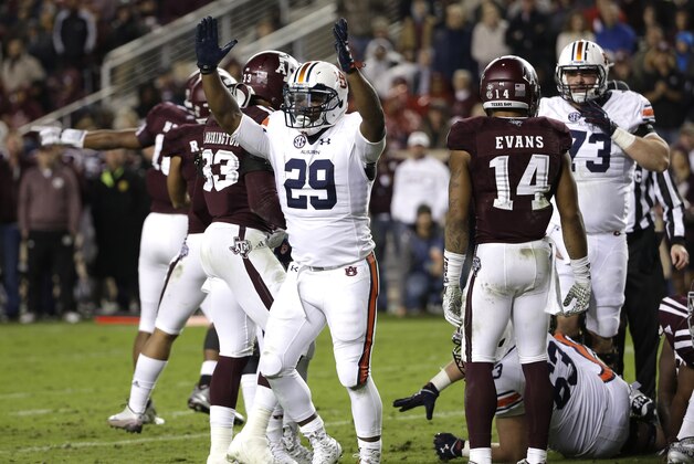 Auburn running back Jovon Robinson (29) raises his arms after rushing for a touchdown against Texas A&M during the second quarter of an NCAA college football game, Saturday, Nov. 7, 2015, in College Station, Texas. (AP Photo/David J. Phillip)