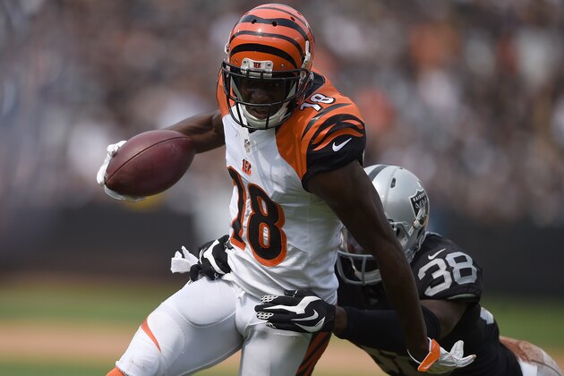 OAKLAND, CA - SEPTEMBER 13:  A.J. Green #18 of the Cincinnati Bengals gets tackled by T.J. Carrie #38 of the Oakland Raiders during their NFL game at the O.co Coliseum on September 13, 2015 in Oakland, California.  (Photo by Thearon W. Henderson/Getty Images)