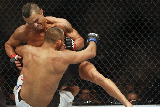 Vitor Belfort,rear, from Brazil, fights Dan Henderson, from the United States, during their UFC middleweight mixed martial arts bout in Sao Paulo, Brazil, early Sunday, Nov. 8, 2015. (AP Photo/Andre Penner)