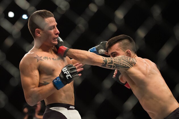 Nov 7, 2015; Sao Paulo, Brazil;  Thomas Almeida (red gloves) fights against Anthony Birchak (blue gloves) during UFC Fight Night at Ibirapuera Gymnasium. Mandatory Credit: Jason Silva-USA TODAY Sports
