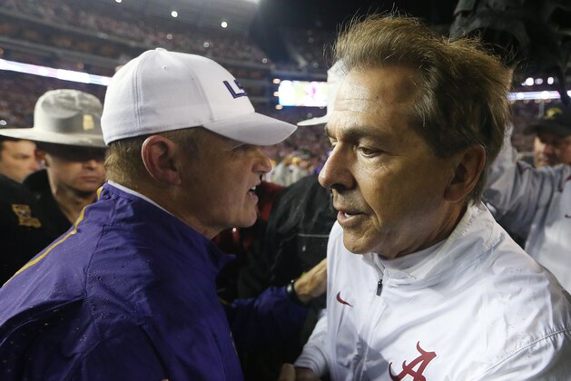LSU head coach Les Miles, left, and Alabama head coach Nick Saban speak at midfield after the second half of an NCAA college football game Saturday, Nov. 7, 2015, in Tuscaloosa , Ala. Alabama won 30-16. (AP Photo/John Bazemore)