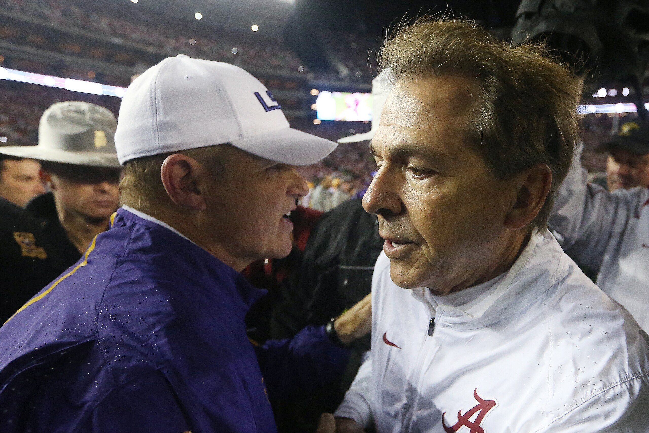 LSU head coach Les Miles, left, and Alabama head coach Nick Saban speak at midfield after the second half of an NCAA college football game Saturday, Nov. 7, 2015, in Tuscaloosa , Ala. Alabama won 30-16. (AP Photo/John Bazemore)