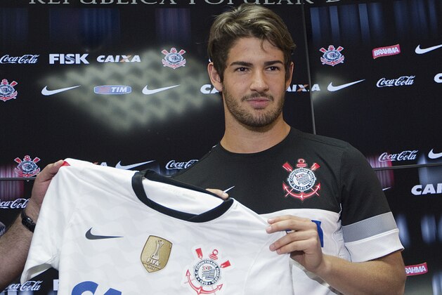 Former AC Milan striker Alexandre Pato poses with Corinthians jerseys during his presentation as Corinthians' new soccer player in Sao Paulo, Brazil, Friday, Jan. 11, 2013. Brazilian player Pato signed a four year contract with the club. (AP Photo/Andre Penner)