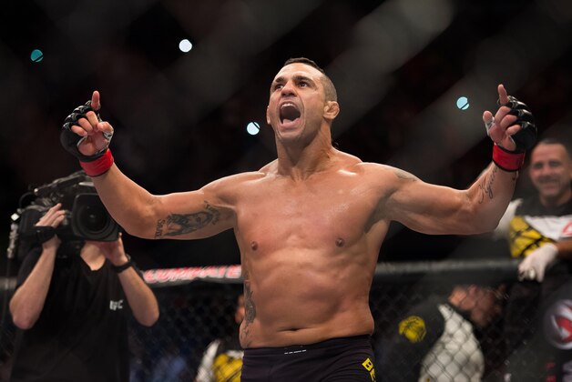 Nov 7, 2015; Sao Paulo, Brazil;  Vitor Belfort (red gloves) reacts after defeating Dan Henderson (blue gloves) during UFC Fight Night at Ibirapuera Gymnasium. Mandatory Credit: Jason Silva-USA TODAY Sports