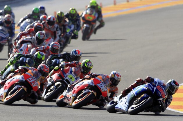 MotoGP rider Jorge Lorenzo of Spain, right, leads the race during the Valencia Motorcycle Grand Prix, the last race of the season, at the Ricardo Tormo circuit in Cheste near Valencia, Spain, Sunday, Nov. 8, 2015. (AP Photo/Alberto Saiz)