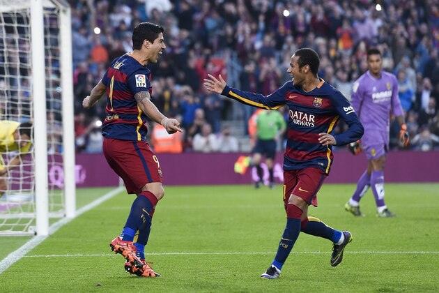 Barcelona's Uruguayan forward Luis Suarez (L) is congratulated by his teammate Barcelona's Brazilian forward Neymar da Silva Santos Junior after scoring during the Spanish league football match FC Barcelona vs Villarreal CF at the Camp Nou stadium in Barcelona on November 8, 2015.   AFP PHOTO/ JOSEP LAGO        (Photo credit should read JOSEP LAGO/AFP/Getty Images)