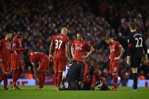 Liverpool's French defender Mamadou Sakho (3R) sits on the pitch as he receives medical treatment during the English Premier League football match between Liverpool and Crystal Palace at the Anfield stadium in Liverpool, north-west England on November 8, 2015.     AFP PHOTO / PAUL ELLIS

RESTRICTED TO EDITORIAL USE. No use with unauthorized audio, video, data, fixture lists, club/league logos or 'live' services. Online in-match use limited to 75 images, no video emulation. No use in betting, games or single club/league/player publications.        (Photo credit should read PAUL ELLIS/AFP/Getty Images)