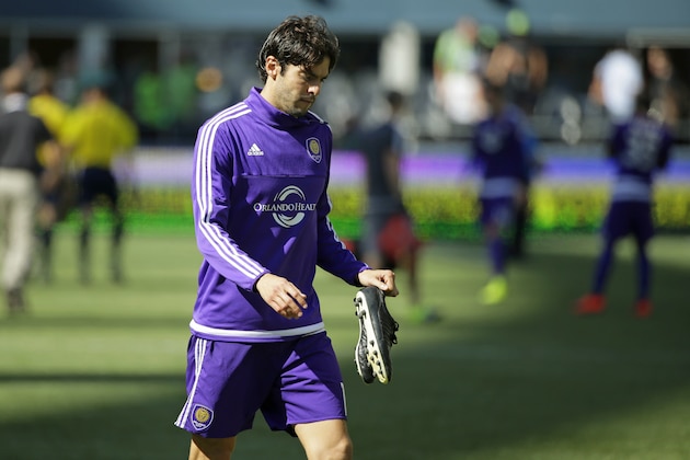 Orlando City's Kaka walks off the pitch carrying his cleats after the Seattle Sounders won 4-0 in an MLS soccer match, Sunday, Aug. 16, 2015, in Seattle.  (AP Photo/Ted S. Warren)