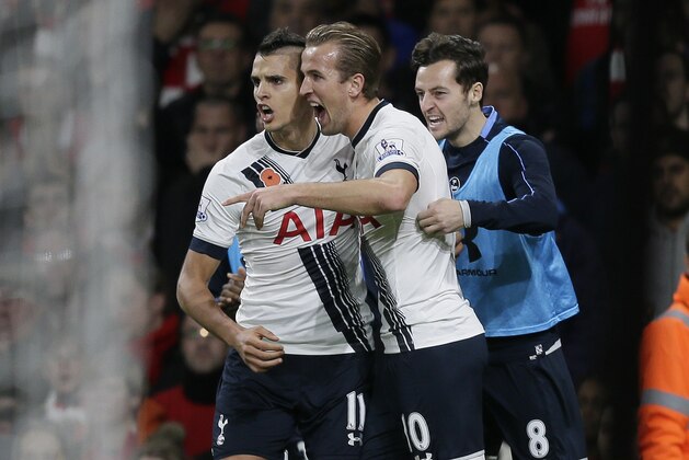 Tottenham’s Harry Kane, centre, celebrates after scoring a goal, with Tottenham’s Erik Lamela, left, and Tottenham’s Ryan Mason during the English Premier League soccer match between Arsenal and Tottenham Hotspur at the Emirates Stadium in London, Sunday Nov. 8, 2015. (AP Photo/Tim Ireland)