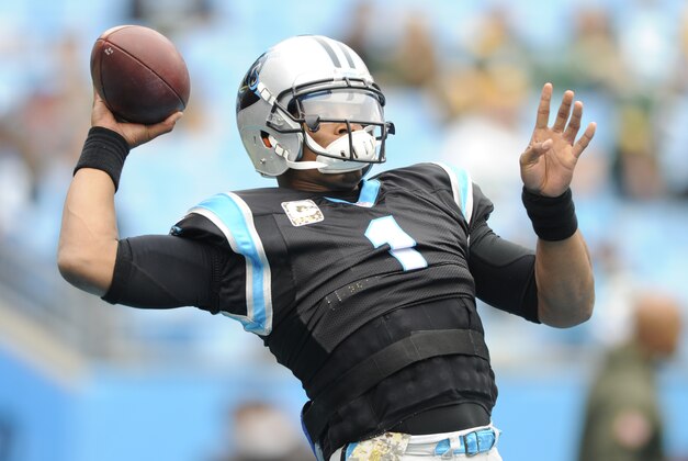 Carolina Panthers' Cam Newton (1) warms up before an NFL football game against the Green Bay Packers in Charlotte, N.C., Sunday, Nov. 8, 2015. (AP Photo/Mike McCarn)
