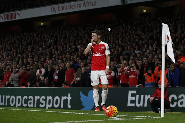 Arsenal's German midfielder Mesut Ozil prepares to take a corner during the English Premier League football match between Arsenal and Tottenham Hotspur at the Emirates Stadium in London on November 8, 2015.     AFP PHOTO / ADRIAN DENNIS

RESTRICTED TO EDITORIAL USE. No use with unauthorized audio, video, data, fixture lists, club/league logos or 'live' services. Online in-match use limited to 75 images, no video emulation. No use in betting, games or single club/league/player publications.        (Photo credit should read ADRIAN DENNIS/AFP/Getty Images)