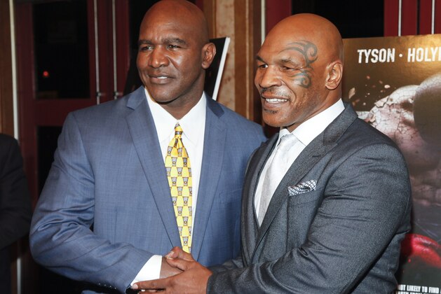 Evander Holyfield, left, and Mike Tyson, attend a special screening of