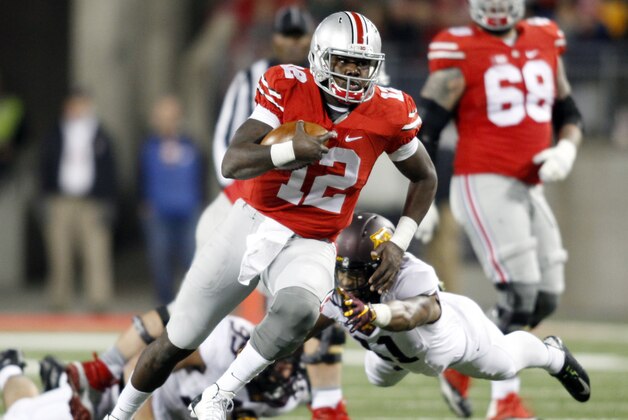 Ohio State quarterback Cardale Jones, left, tries to get past  Minnesota Antonio Johnson during an NCAA college football game Saturday, Nov. 7, 2015, in Columbus, Ohio. Ohio State beat Minnesota 28-14. (AP Photo/Paul Vernon)