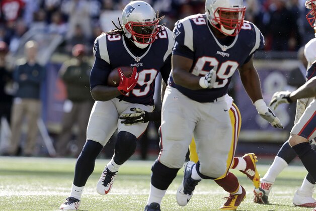 New England Patriots running back LeGarrette Blount (29) runs behind a block by offensive lineman Shaq Mason (69) against the Washington Redskins during the first half of an NFL football game, Sunday, Nov. 8, 2015, in Foxborough, Mass. (AP Photo/Charles Krupa)