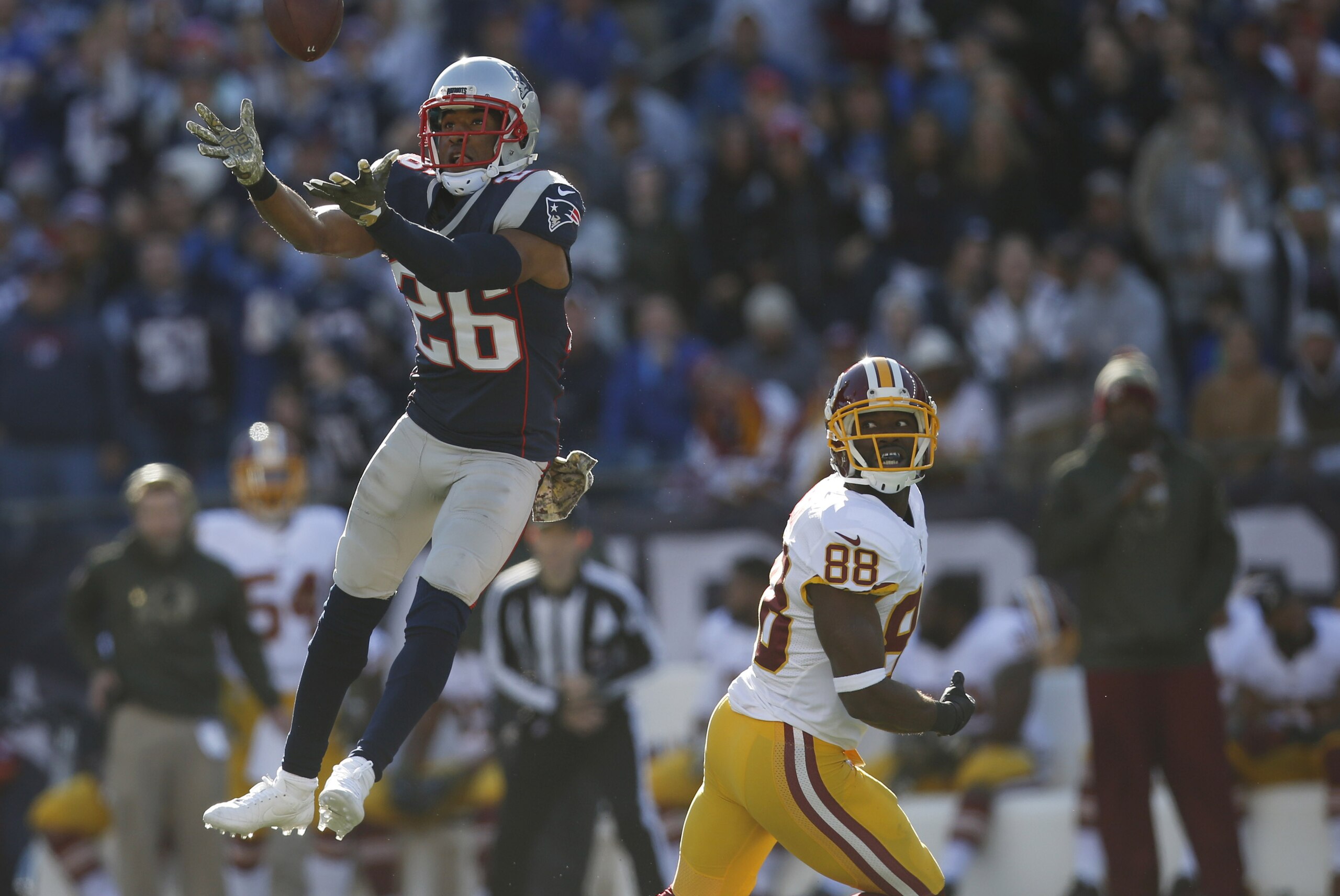 Nov 8, 2015; Foxborough, MA, USA; New England Patriots cornerback Logan Ryan (26) intercepts a pass intended for Washington Redskins wide receiver Pierre Garcon (88) during the first quarter at Gillette Stadium. Mandatory Credit: Greg M. Cooper-USA TODAY Sports