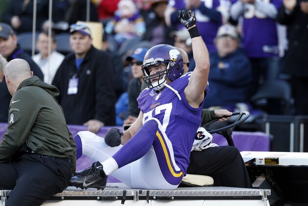 Minnesota Vikings middle linebacker Audie Cole (57) acknowledges the fans as he's carted off during the second half of an NFL football game against the St. Louis Rams, Sunday, Nov. 8, 2015, in Minneapolis. (AP Photo/Jim Mone)