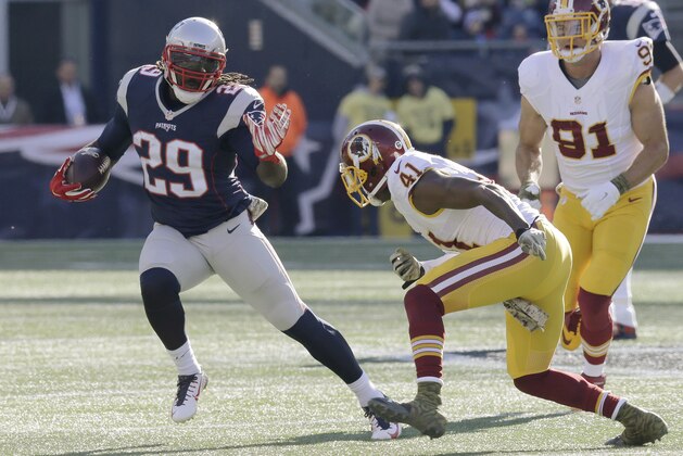 New England Patriots running back LeGarrette Blount (29) runs from Washington Redskins cornerback Will Blackmon (41) during the first half of an NFL football game, Sunday, Nov. 8, 2015, in Foxborough, Mass. (AP Photo/Charles Krupa)