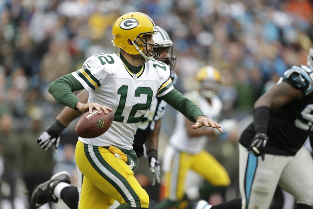 Green Bay Packers' Aaron Rodgers (12) scrambles against the Carolina Panthers in the second half of an NFL football game in Charlotte, N.C., Sunday, Nov. 8, 2015. (AP Photo/Bob Leverone)