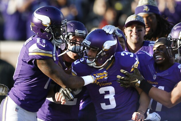 Minnesota Vikings kicker Blair Walsh (3) is surrounded by teammates after his 40-yard field goal during overtime of an NFL football game against the St. Louis Rams, Sunday, Nov. 8, 2015, in Minneapolis. (AP Photo/Jim Mone)