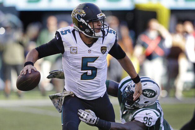 Jacksonville Jaguars quarterback Blake Bortles (5) is pressured by New York Jets defensive end Muhammad Wilkerson (96) during the third quarter of an NFL football game, Sunday, Nov. 8, 2015, in East Rutherford, N.J. (AP Photo/Seth Wenig)