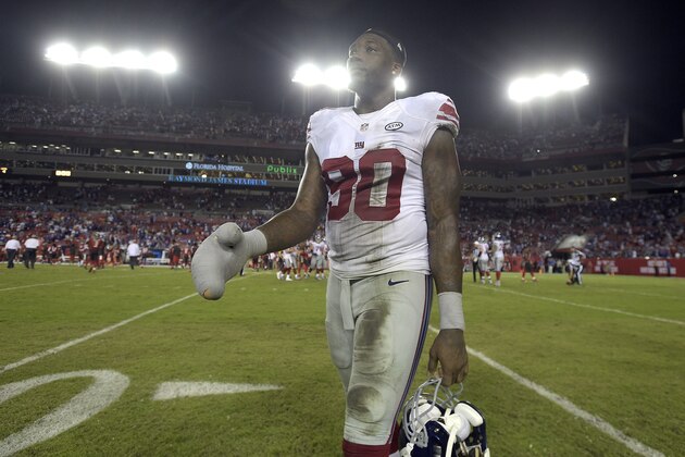 New York Giants defensive end Jason Pierre-Paul heads back to the sidelines after the Giants defeated the Tampa Bay Buccaneers 32-18 during an NFL football game Sunday, Nov. 8, 2015, in Tampa, Fla. (AP Photo/Phelan M. Ebenhack)