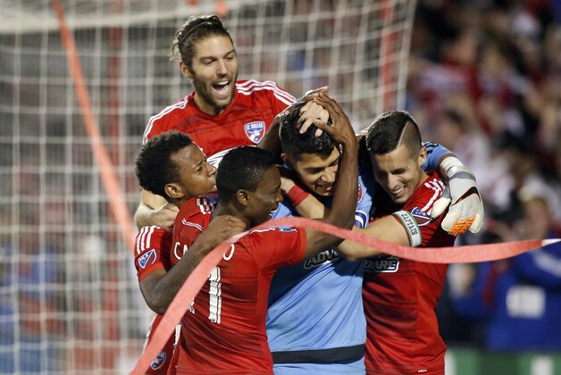 FC Dallas goalkeeper Jesse Gonzalez (44) is mobbed by teammates after winning 4-2 against the Seattle Sounders FC  during the shootout period of an MLS soccer western conference semifinal playoff match Sunday, Nov. 8, 2015, in Frisco, Texas. FC Dallas players left to right are Kellyn Acosta, Ryan Hollingshead, Fabian Castillo, goalkeeper Jesse Gonzalez and Matt Hedges. (AP Photo/Brad Loper)