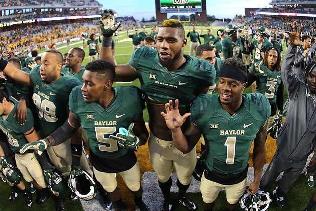 Baylor wide receiver Antwan Goodley (5), Baylor defensive end Shawn Oakman (2), center, and Baylor wide receiver Corey Coleman (1) give the Sic'em Bears sign after defeating Kansas 60-14 in a NCAA college football game, Saturday, Nov. 1, 2014, in Waco, Texas. (AP Photo/ Jerry Larson)