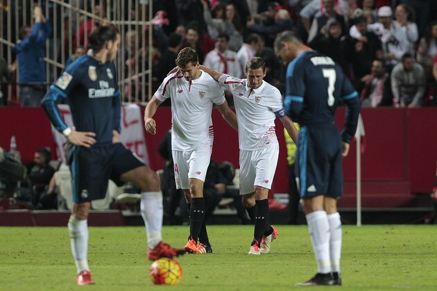 Sevilla's Llorente, second right, celebrates with teammate Grzegorz Krychowiak after scoring against Real Madrid during their La Liga soccer match at the Ramon Sanchez Pizjuan stadium, in Seville, Spain on Sunday, Nov. 8, 2015. (AP Photo/Angel Fernandez)