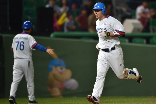 Baseball player Park Byung-Ho of South Korea (R) rounds the bases after hitting a homerun during the men's semifinal game 14 against China at Munhak Baseball Stadium during the 17th Asian Games in Incheon on September 27, 2014. AFP PHOTO / Bay ISMOYO        (Photo credit should read BAY ISMOYO/AFP/Getty Images)