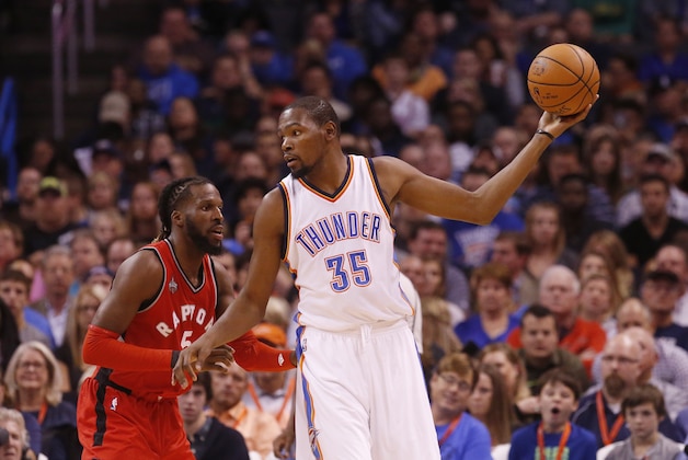 Oklahoma City Thunder forward Kevin Durant (35) looks to move around Toronto Raptors forward DeMarre Carroll (5) during an NBA basketball game in Oklahoma City, Wednesday, Nov. 4, 2015. (AP Photo/Sue Ogrocki)