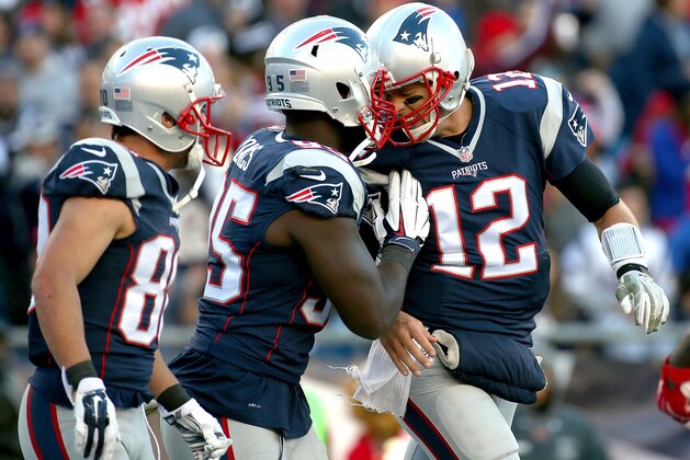 FOXBORO, MA - NOVEMBER 8: Tom Brady #12 of the New England Patriots celebrates Chandler Jones #95  after Brandon Bolden #38 of the New England Patriots, not seen caught a touchdown pass against the Washington Redskins defends in the second half at Gillette Stadium on November 8, 2015 in Foxboro, Massachusetts. (Photo by Jim Rogash/Getty Images)