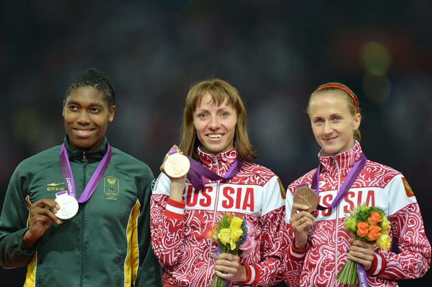 Russia's gold medalist Mariya Savinova (C), South Africa's silver medalist Caster Semenya (L) and Russia's bronze medalist Ekaterina Poistogova celebrate on the podium of the women's 800m at the athletics event of the London 2012 Olympic Games on August 11, 2012 in London.  AFP PHOTO / JOHANNES EISELE        (Photo credit should read JOHANNES EISELE/AFP/GettyImages)