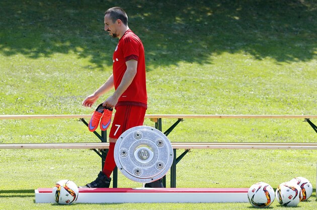 Bayern's Franck Ribery from France walks past the German soccer league trophy prior to an official photo shooting for the upcoming German first division Bundesliga soccer season in Munich, Germany, Thursday, July 16, 2015. (AP Photo/Matthias Schrader)