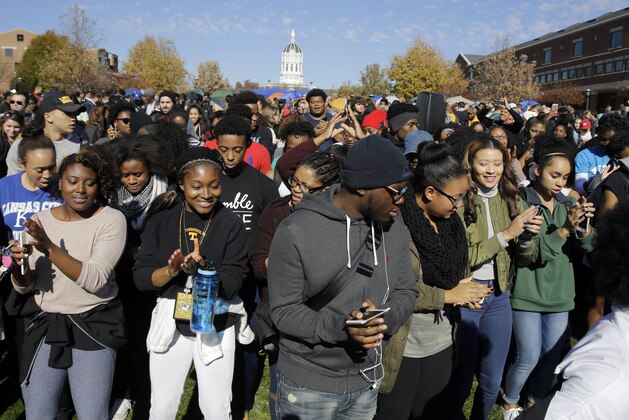 Students dance following University of Missouri System President Tim Wolfe's resignation announcement Monday, Nov. 9, 2015, at the school in Columbia, Mo. The president resigned Monday with the football team and others on campus in open revolt over his handling of racial tensions at the school. (AP Photo/Jeff Roberson)