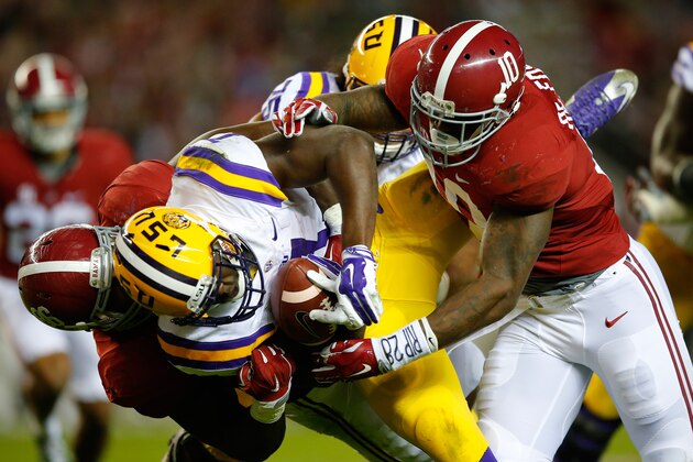 TUSCALOOSA, AL - NOVEMBER 07:  Leonard Fournette #7 of the LSU Tigers is tackled by Reuben Foster #10 and Truett Harris #86 of the Alabama Crimson Tide in the third quarter at Bryant-Denny Stadium on November 7, 2015 in Tuscaloosa, Alabama.  (Photo by Kevin C. Cox/Getty Images)