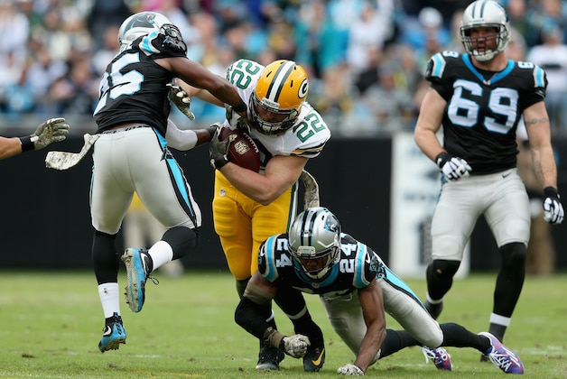 CHARLOTTE, NC - NOVEMBER 08:  Aaron Ripkowski #22 of the Green Bay Packers runs the ball against  Bene' Benwikere #25 and Josh Norman #24 of the Carolina Panthers in the 1st quarter during their game at Bank of America Stadium on November 8, 2015 in Charlotte, North Carolina.  (Photo by Streeter Lecka/Getty Images)