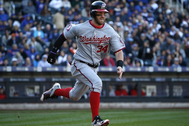 Washington Nationals Bryce Harper, trying for the National League batting title, runs out a ground ball in the seventh inning of a baseball game in New York, Sunday, Oct. 4, 2015. (AP Photo/Kathy Willens)