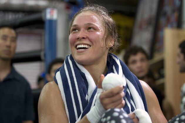 FILE - This July 15, 2015, file photo shows mixed martial arts fighter Ronda Rousey smiles during her workout at Glendale Fighting Club, in Glendale, Calif. Paramount Pictures said Monday, Aug. 3, that it has acquired the rights to Rousey’s autobiography “My Fight/Your Fight,” with plans for Rousey to play herself in the adaptation. (AP Photo/Jae C. Hong, File) FILE - This July 15, 2015, file photo shows mixed martial arts fighter Ronda Rousey smiles during her workout at Glendale Fighting Club, in Glendale, Calif. Paramount Pictures said Monday, Aug. 3, that it has acquired the rights to Rousey’s autobiography “My Fight/Your Fight,” with plans for Rousey to play herself in the adaptation. (AP Photo/Jae C. Hong, File)