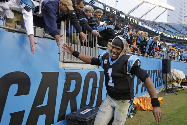 Carolina Panthers' Cam Newton (1) celebrates with fans after an NFL football game against the Green Bay Packers in Charlotte, N.C., Sunday, Nov. 8, 2015. The Panthers won 37-29. (AP Photo/Bob Leverone)