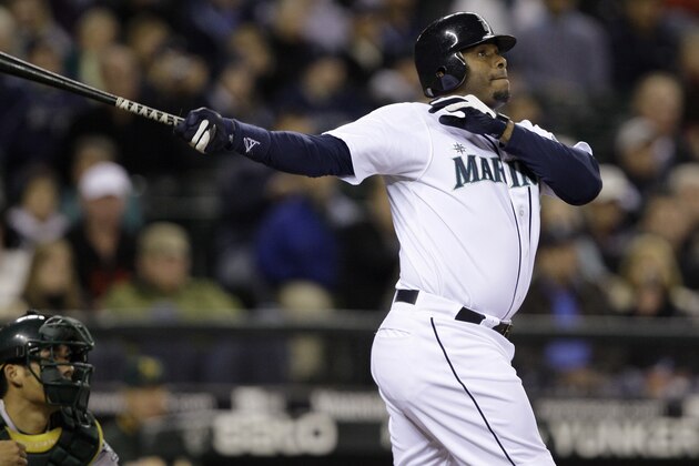 Seattle Mariners' Ken Griffey Jr. watches his three-run home run along with Oakland Athletics catcher Kurt Suzuki during the fifth inning of a baseball game Tuesday, Sept. 29, 2009, in Seattle. (AP Photo/Elaine Thompson)